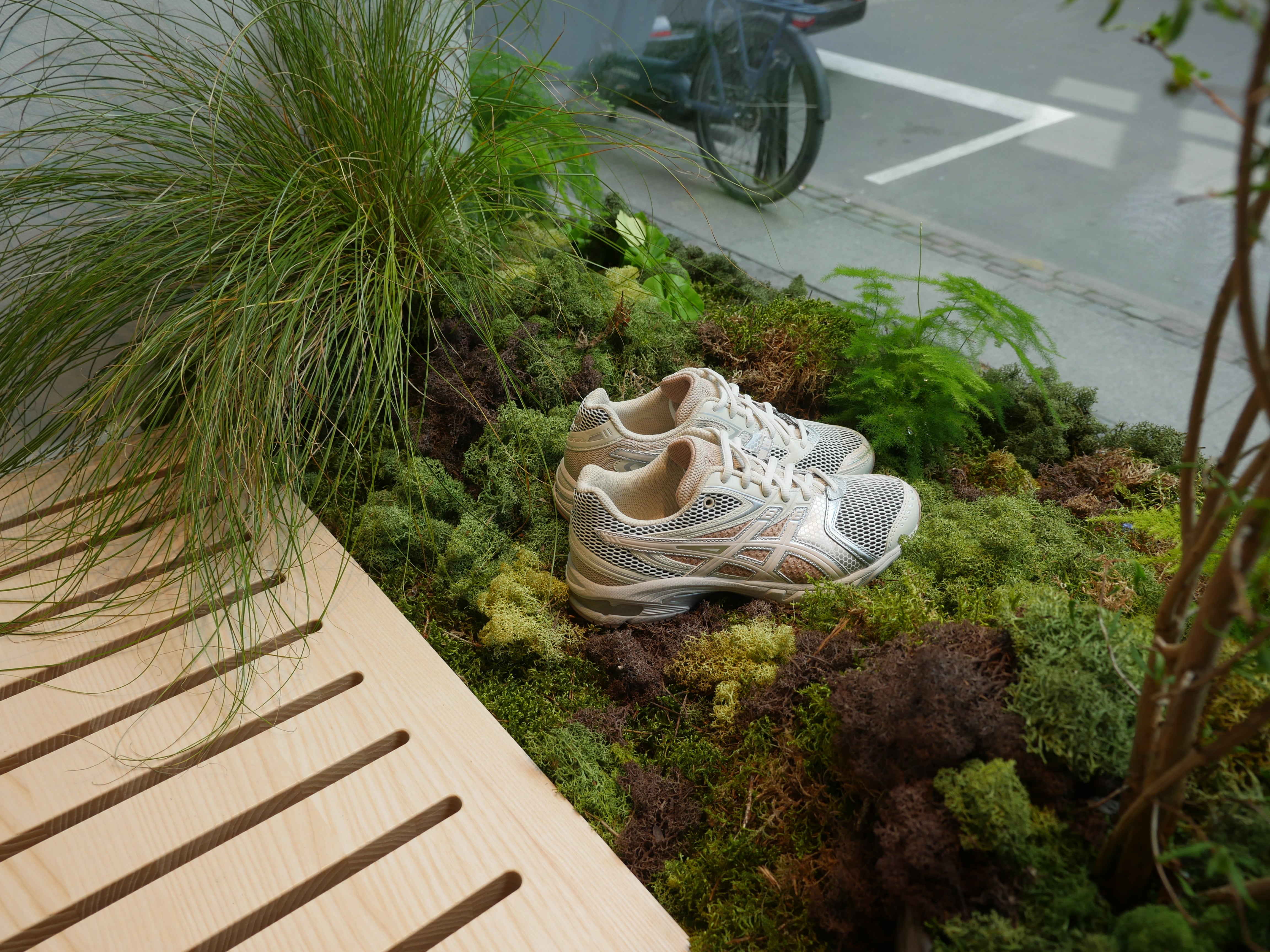 Floral window design for ASICS, combining seasonal flowers with a clean, sporty and dynamic aesthetic.